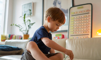 Boy interacting with toy in the background is Springboard from Charmspring