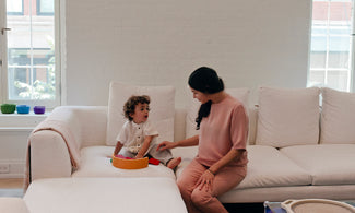 mom and son chatting while playing with building toy