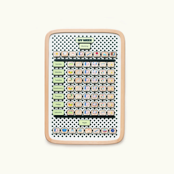 A large wooden springboard with colorful activity tiles arranged in a grid pattern, including tiles for days of the week and routines such as 'Morning', 'Night', and 'My Week'. The springboard has a dotted pattern background and a beige border.