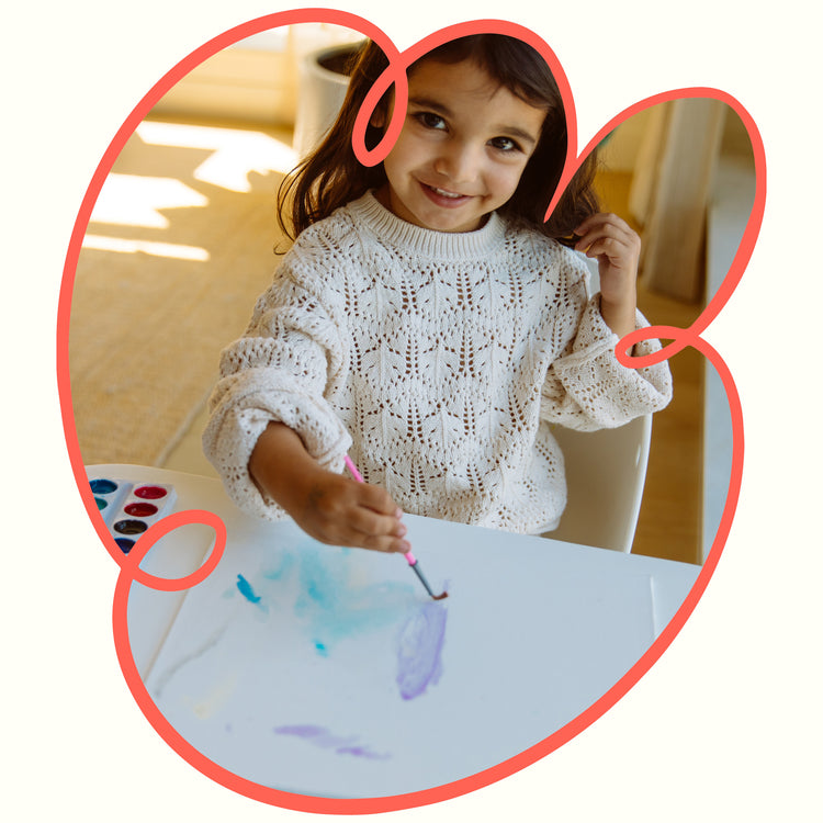 Girl painting at table