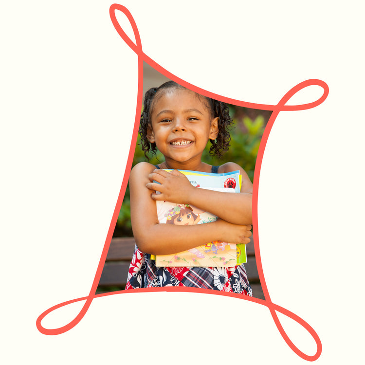 Girl holding book and smiling