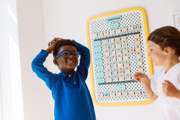 Two kids laughing in front of a Large Springboard