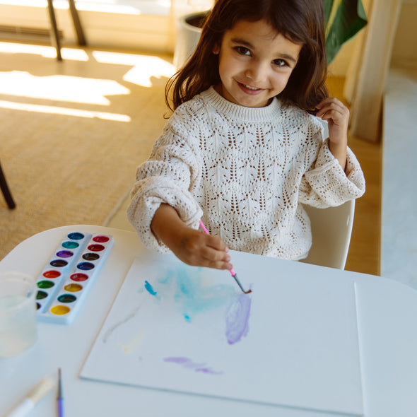 Girl painting at table
